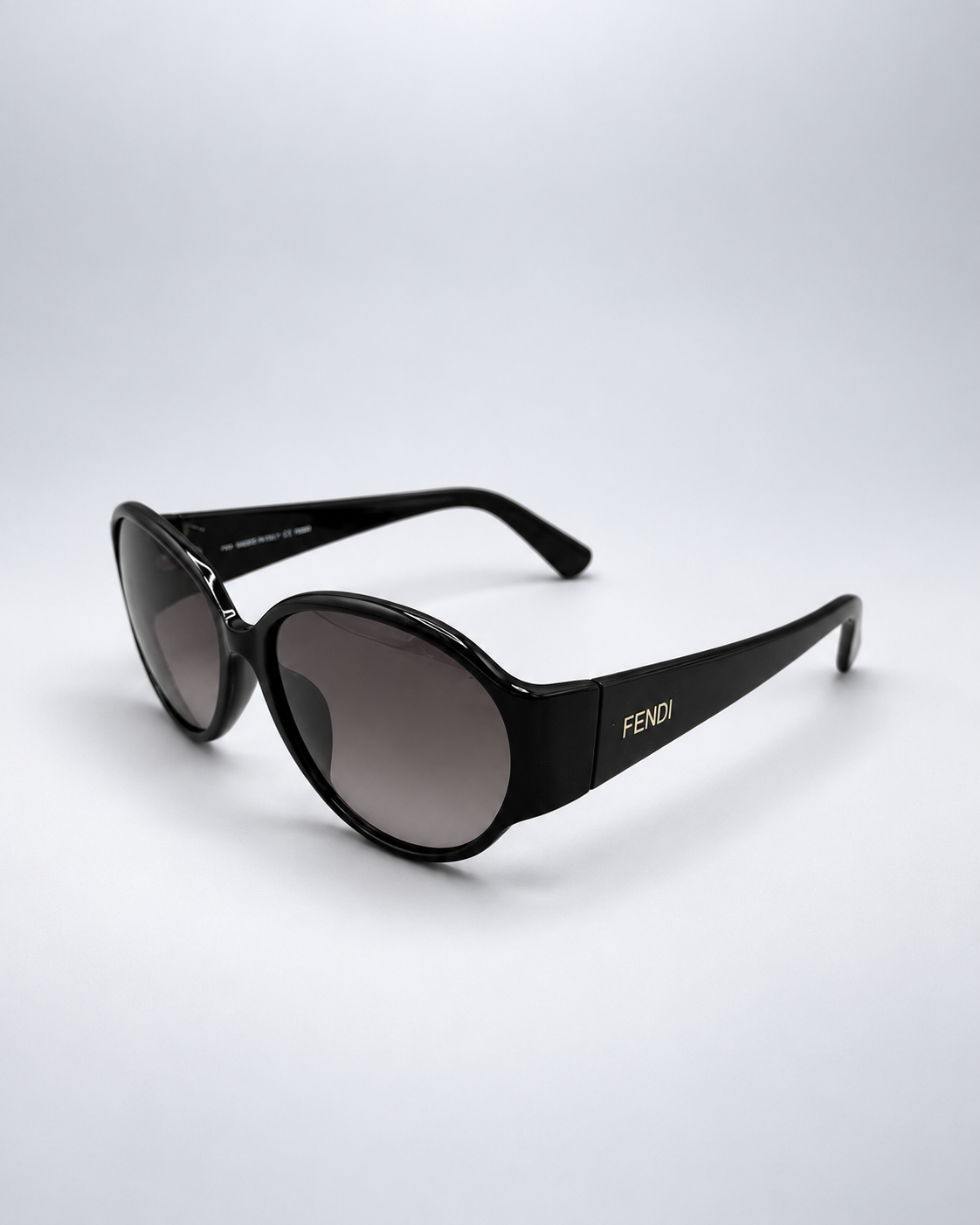 Sunglasses photographed against a soft light gray studio background