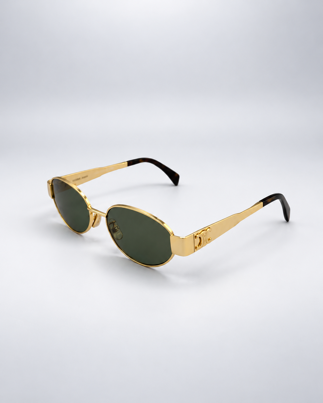Sunglasses photographed against a soft light gray studio background