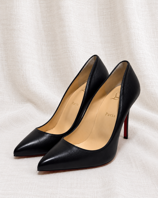 CHRISTIAN LOUBOUTIN, Black Pumps, 41 — left-facing pair on ivory linen