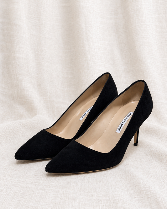 MANOLO BLAHNIK, MSRP $895 Black Suede Pumps, 38 — left-facing pair on ivory linen
