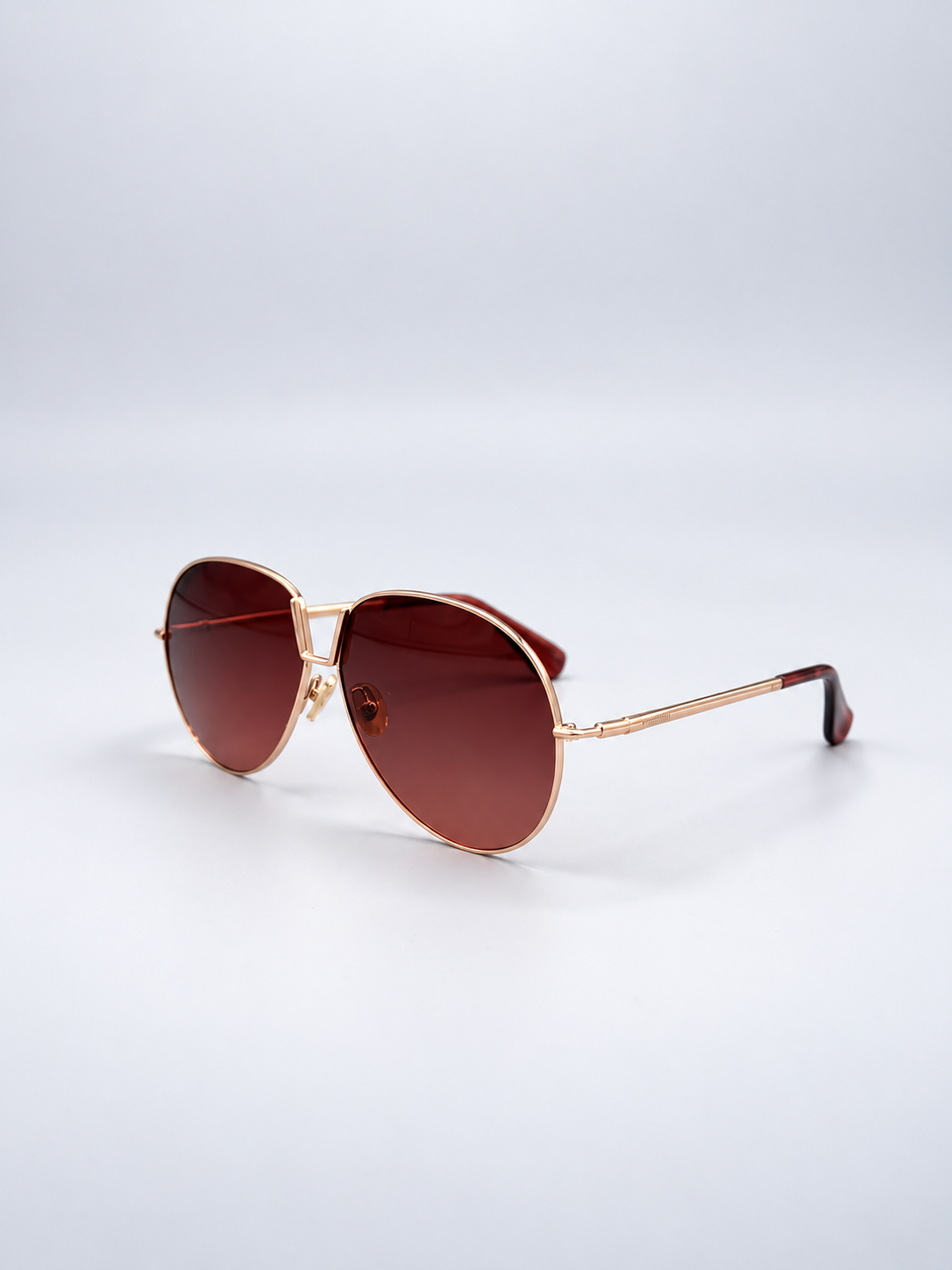 Sunglasses photographed on a pale gray studio background