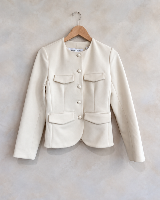 VERONICA BEARD, Button Up Short Jacket W Pockets, S on a wooden hanger against a softly mottled pale wall