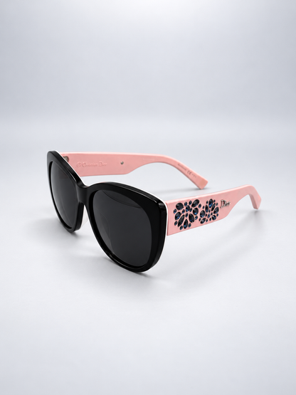 Sunglasses photographed against a soft light gray studio background