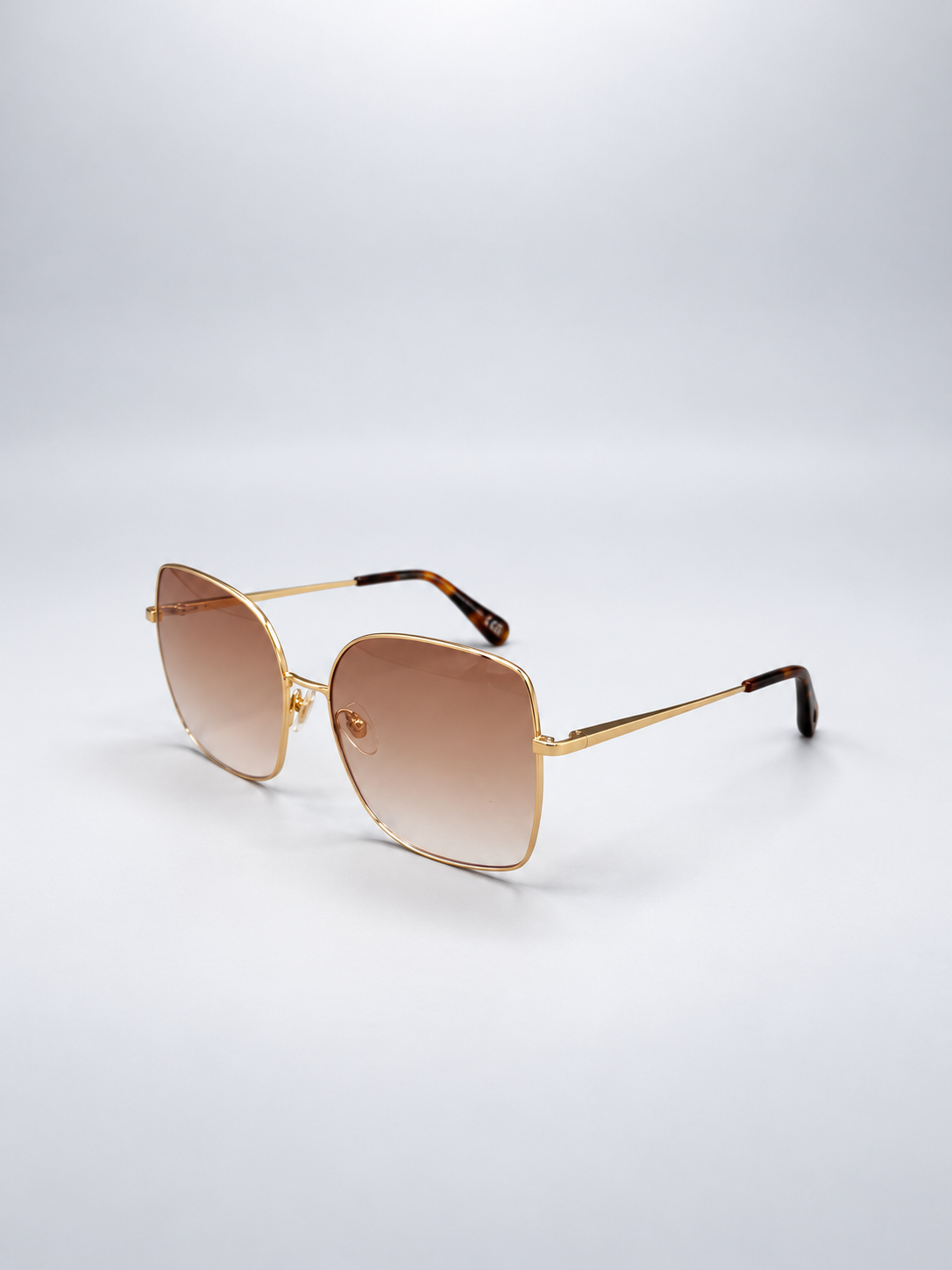 Sunglasses photographed against a soft light gray studio background