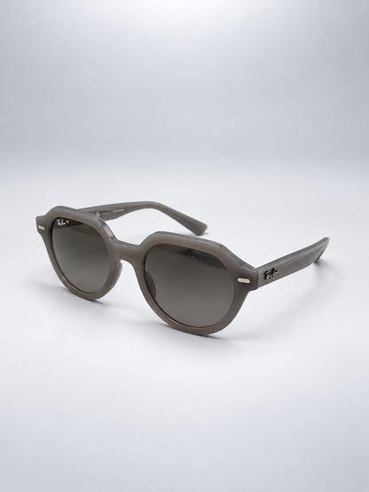 Sunglasses photographed against a soft light gray studio background