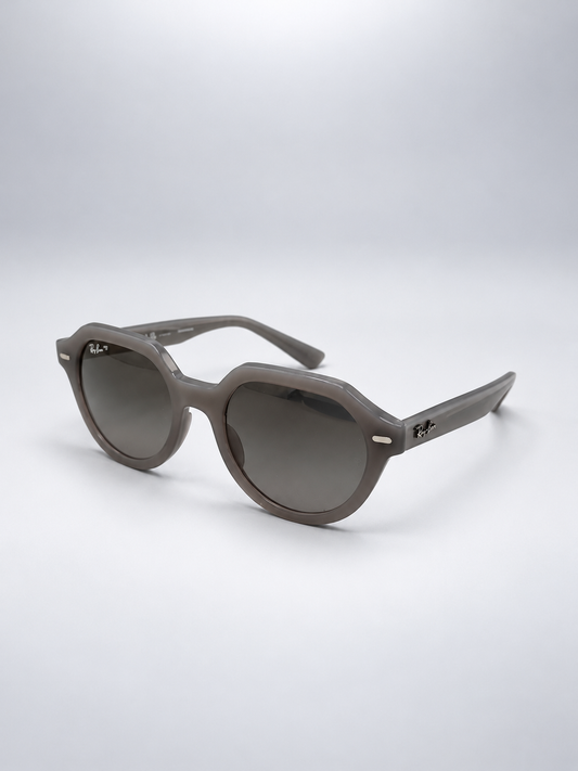 Sunglasses photographed against a soft light gray studio background