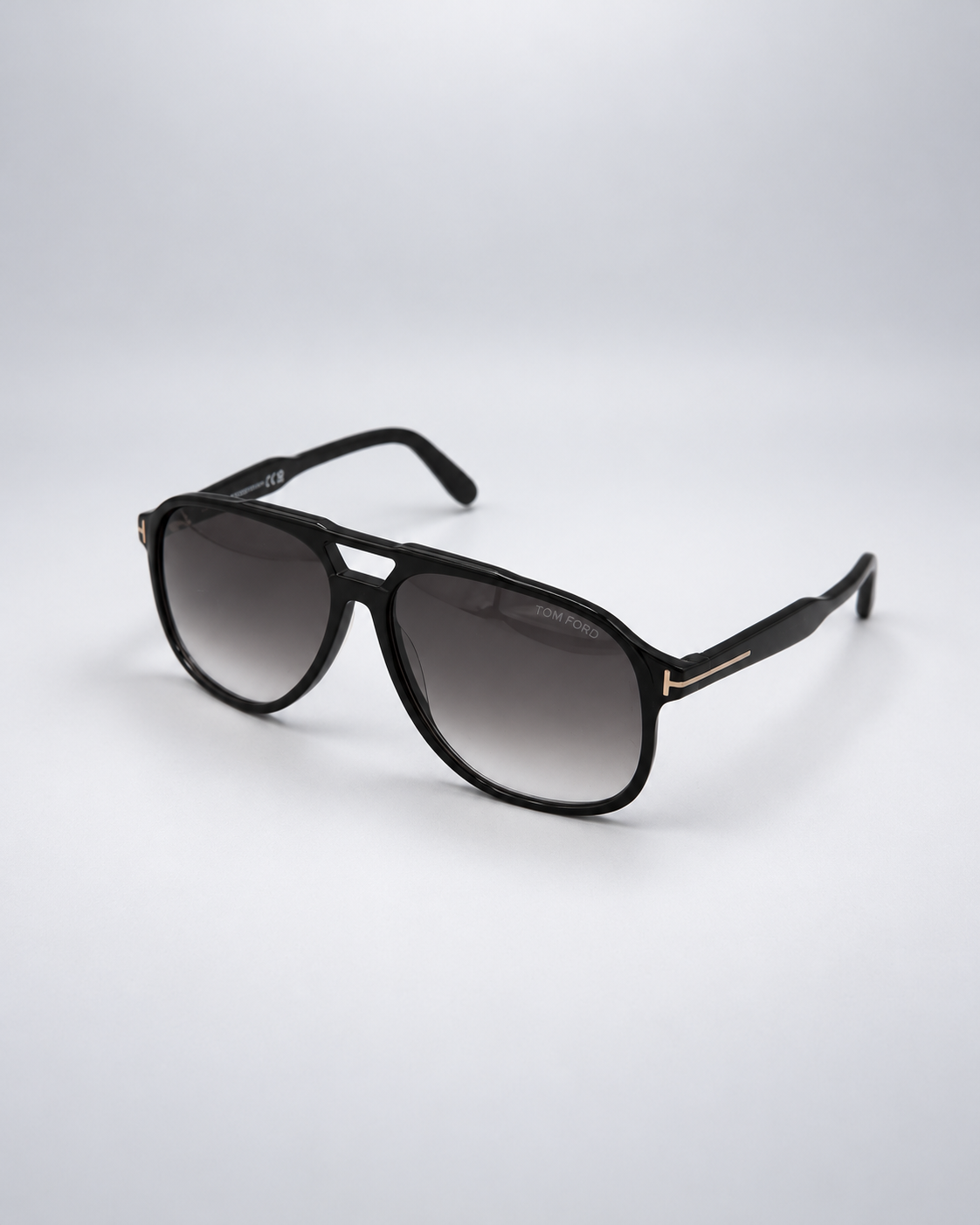 Sunglasses photographed against a soft light gray studio background